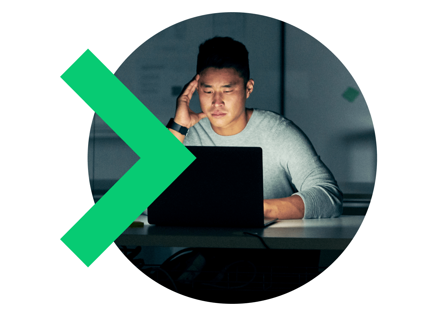 Man frowning working on his laptop late at night